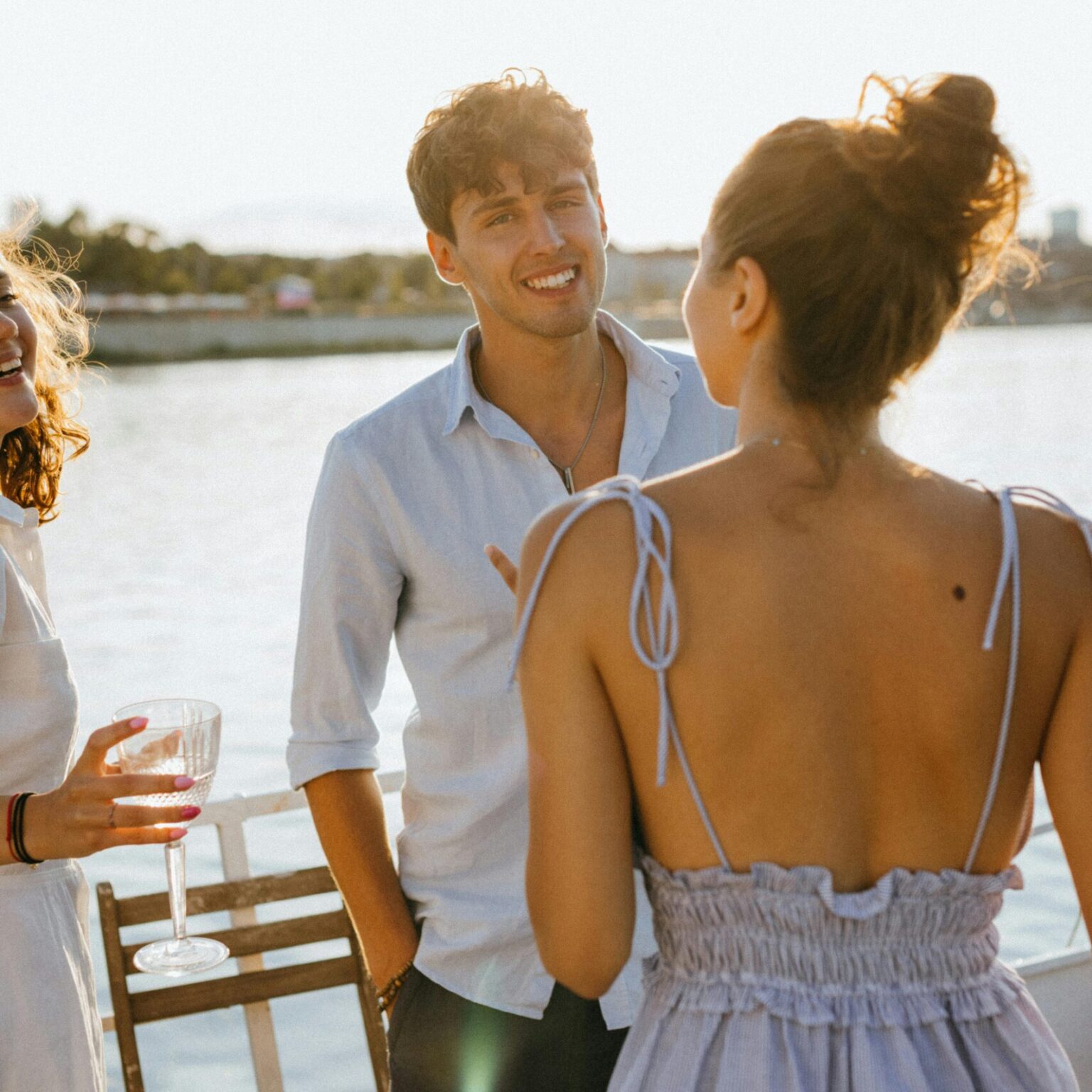 Guests chatting with drinks on deck during a Thames boat party