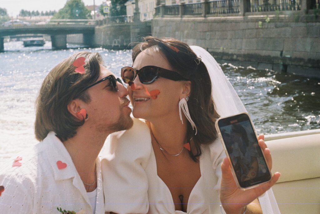 Couple sharing a kiss on a boat on the river